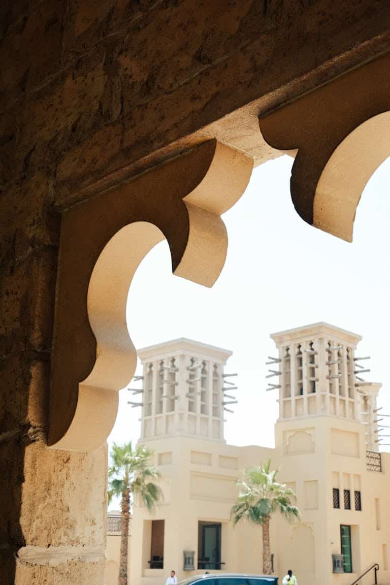 View through an archway of traditional wind towers in Dubai, UAE.
